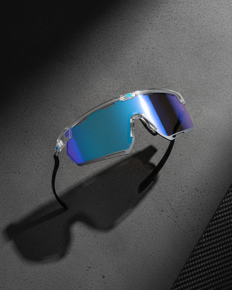 Sunglasses with blue reflective lenses on a dark surface