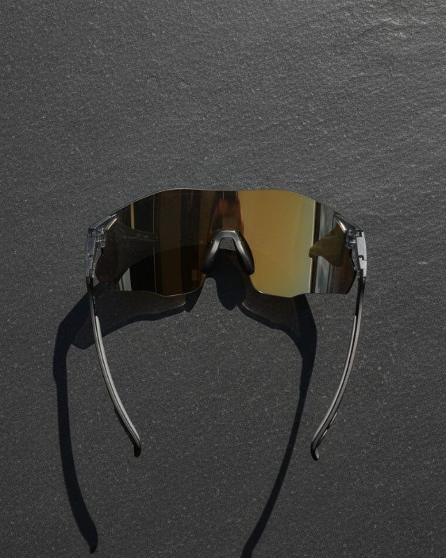 Sunglasses with reflective lenses on a dark gray background