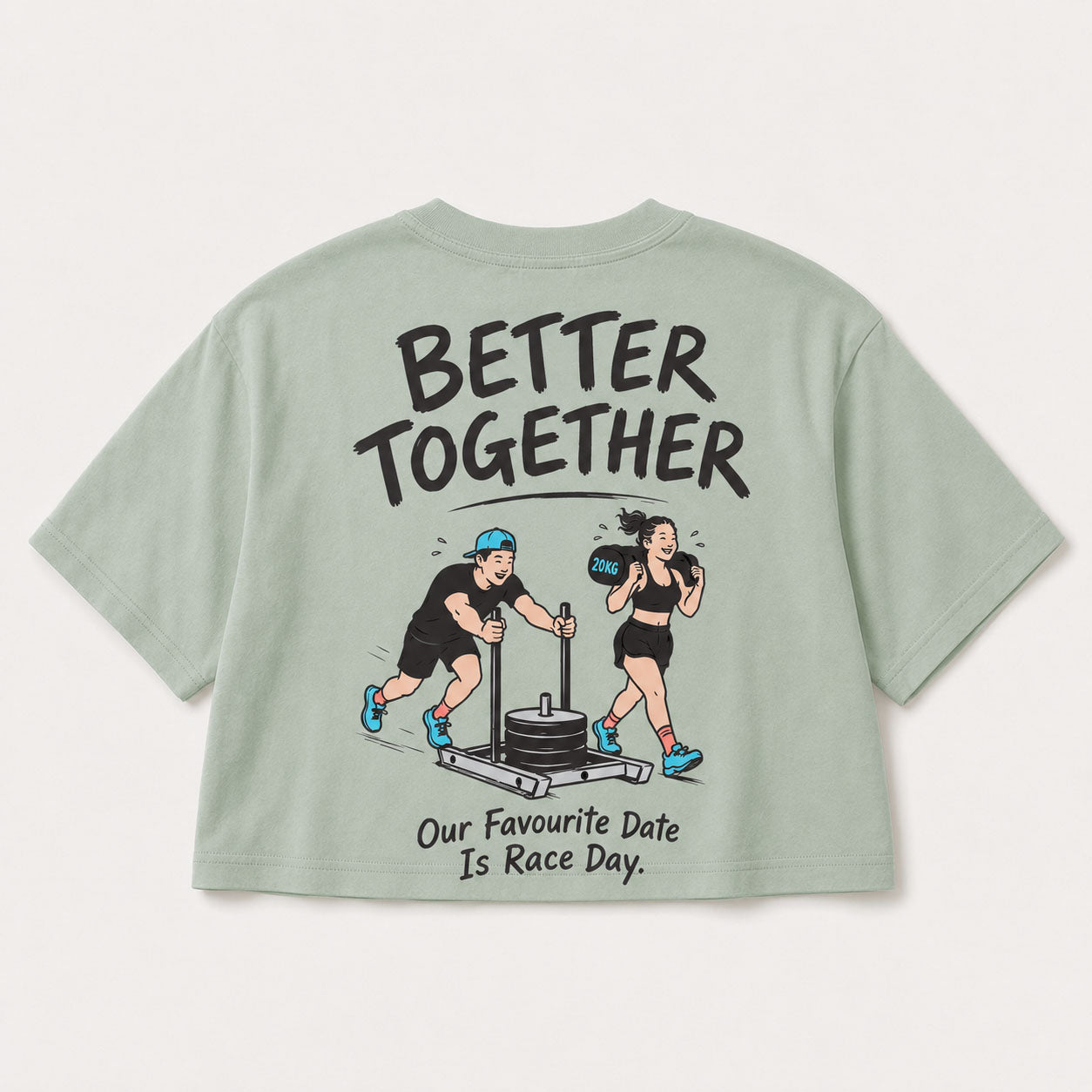 A sage green short-sleeve t-shirt shown from the back, featuring a cartoon graphic of a man pushing a weight stack and a woman boxing, with the text 'BETTER TOGETHER' and 'Our Favourite Date Is Race Day.'.