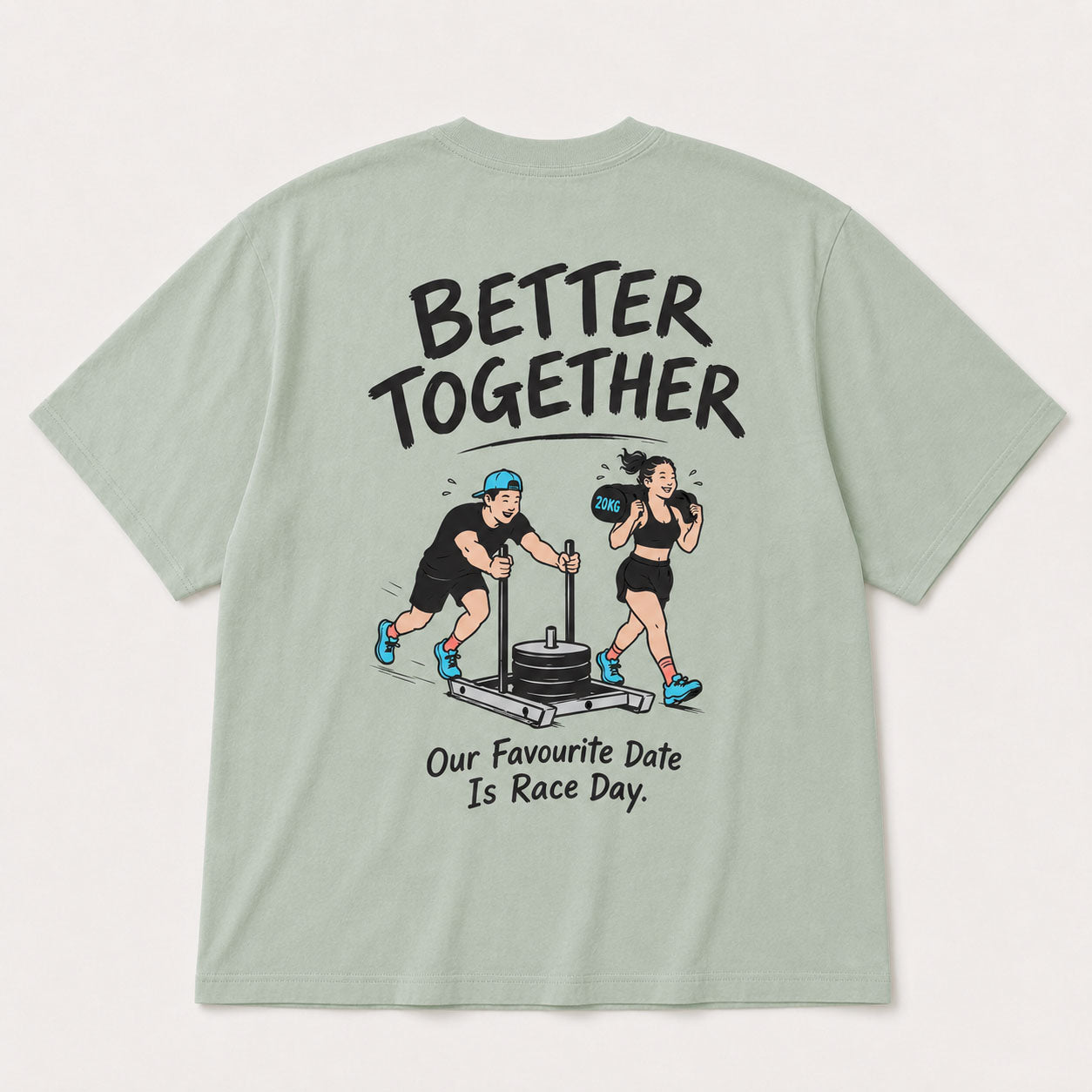 A sage green short-sleeve t-shirt shown from the back, featuring a large graphic print of a man and a woman exercising together with the text 'BETTER TOGETHER' and 'Our Favourite Date Is Race Day.'.