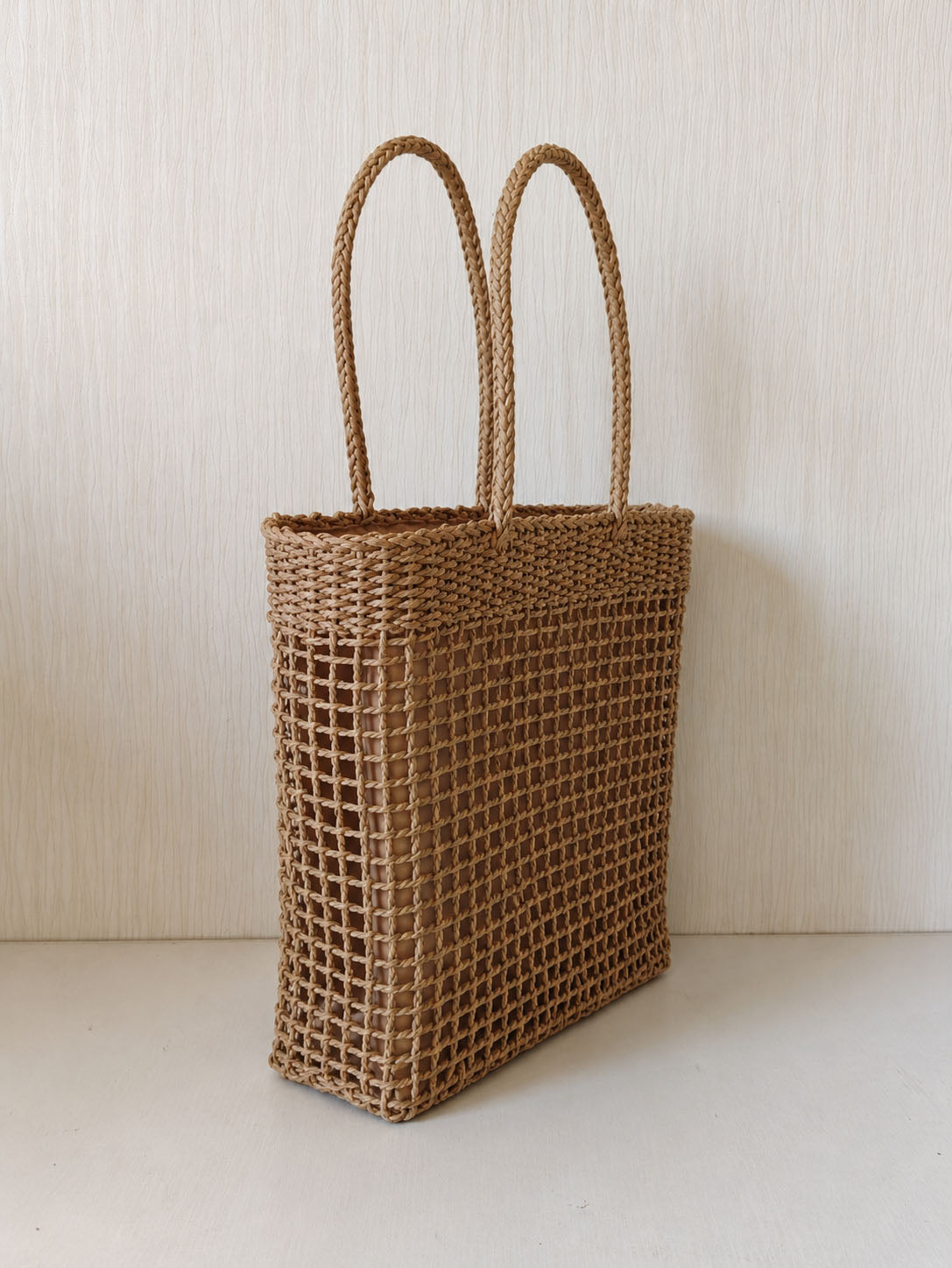 Natural open-weave texture and long shoulder handles on The Carryall Bag